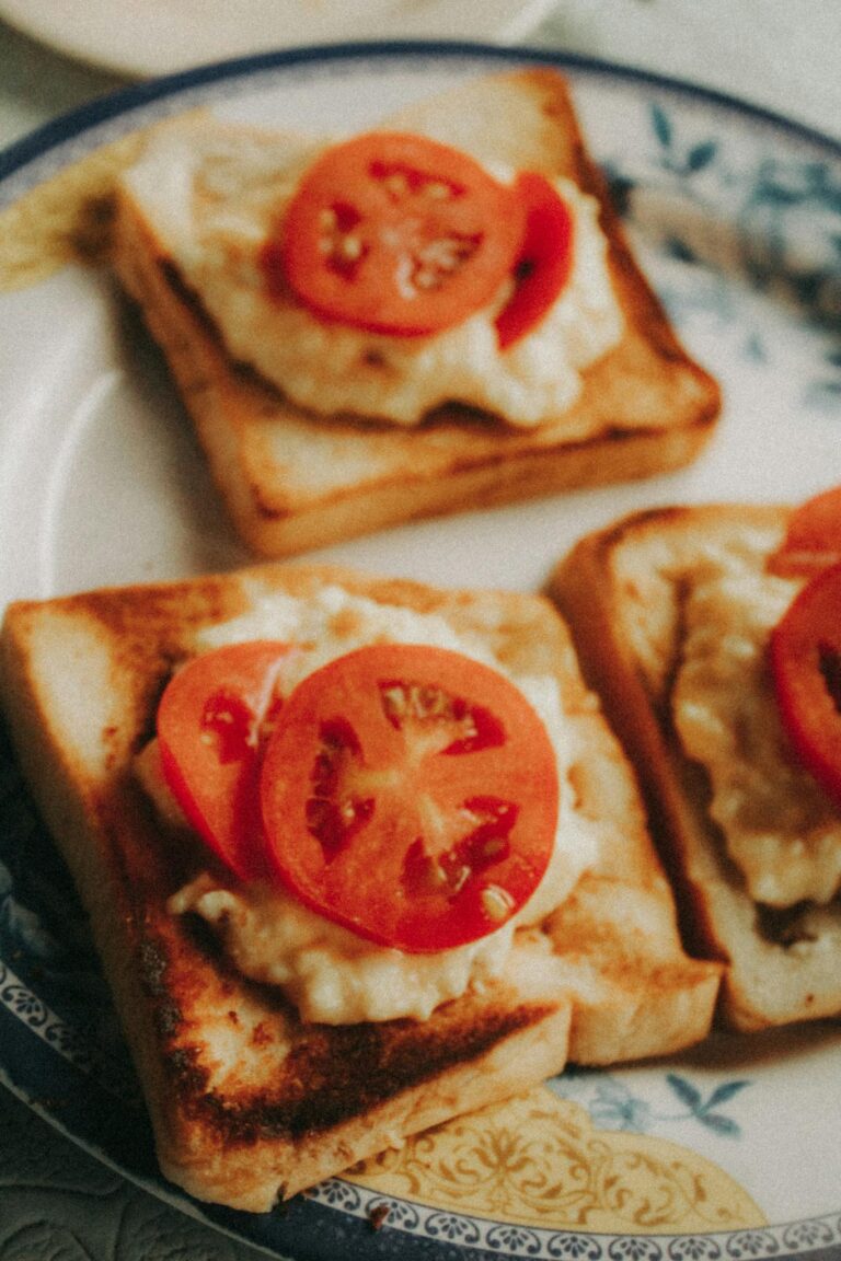 Appetizing close-up of tomato slices and egg salad on toasted bread. Perfect breakfast idea.