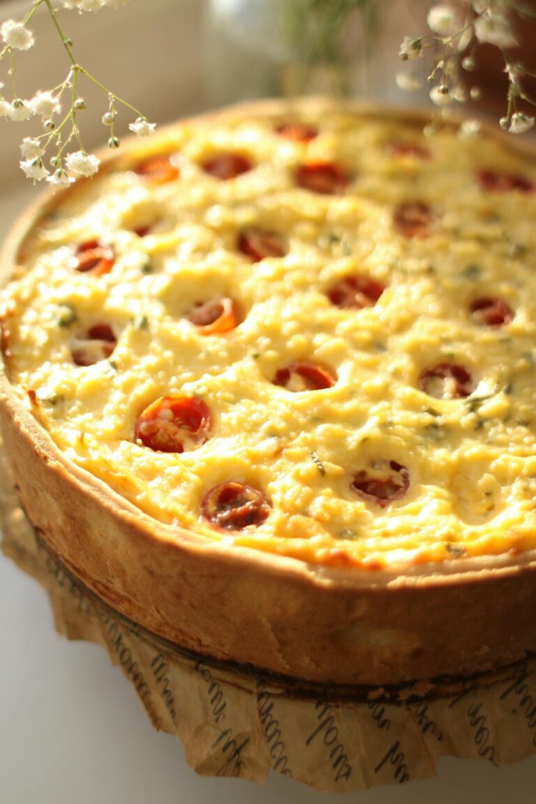 Freshly baked quiche with tomatoes and cheese, perfect for a delightful homemade meal.